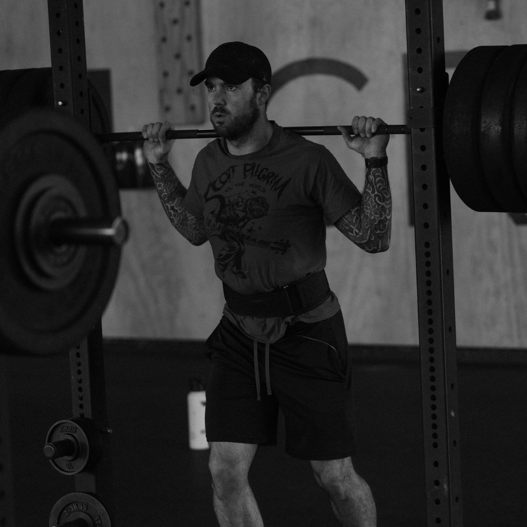 Member squatting with barbell